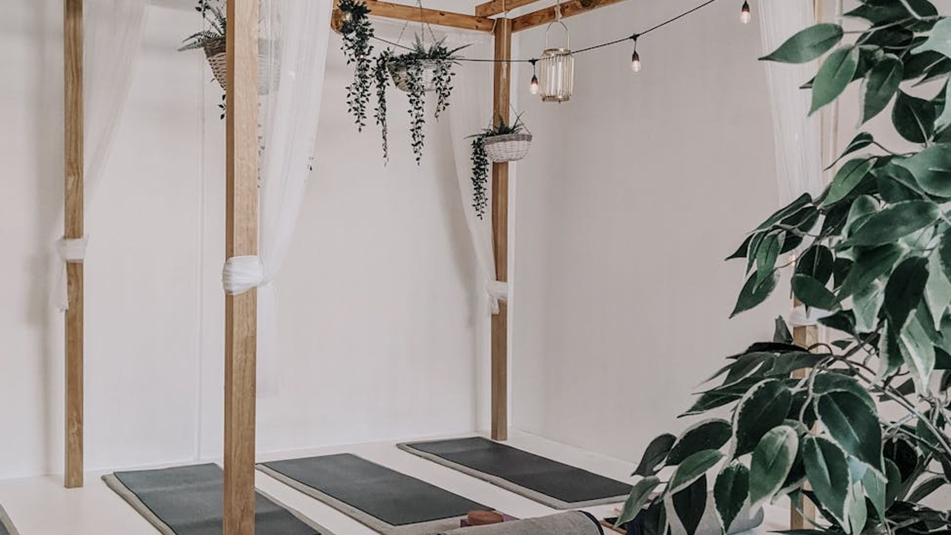 Soft sunlight in a clean yoga studio space with wooden floor